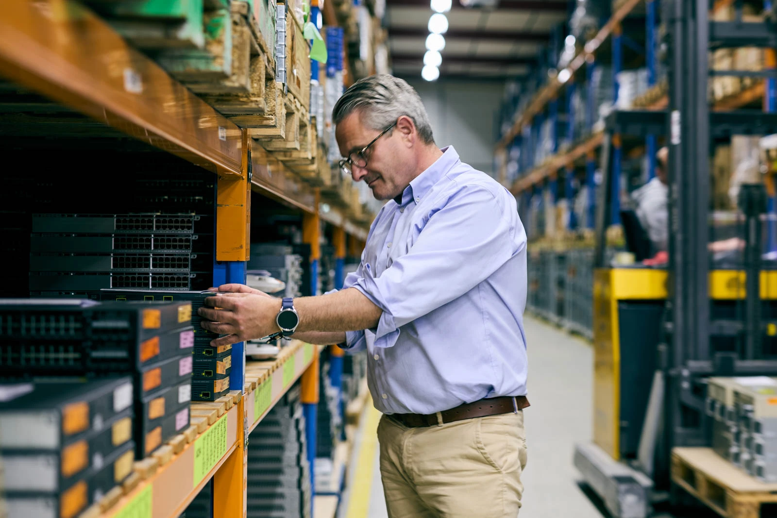 Technicien configurant du matériel réseau d’entreprise dans un entrepôt pendant une pénurie mondiale de mémoire RAM